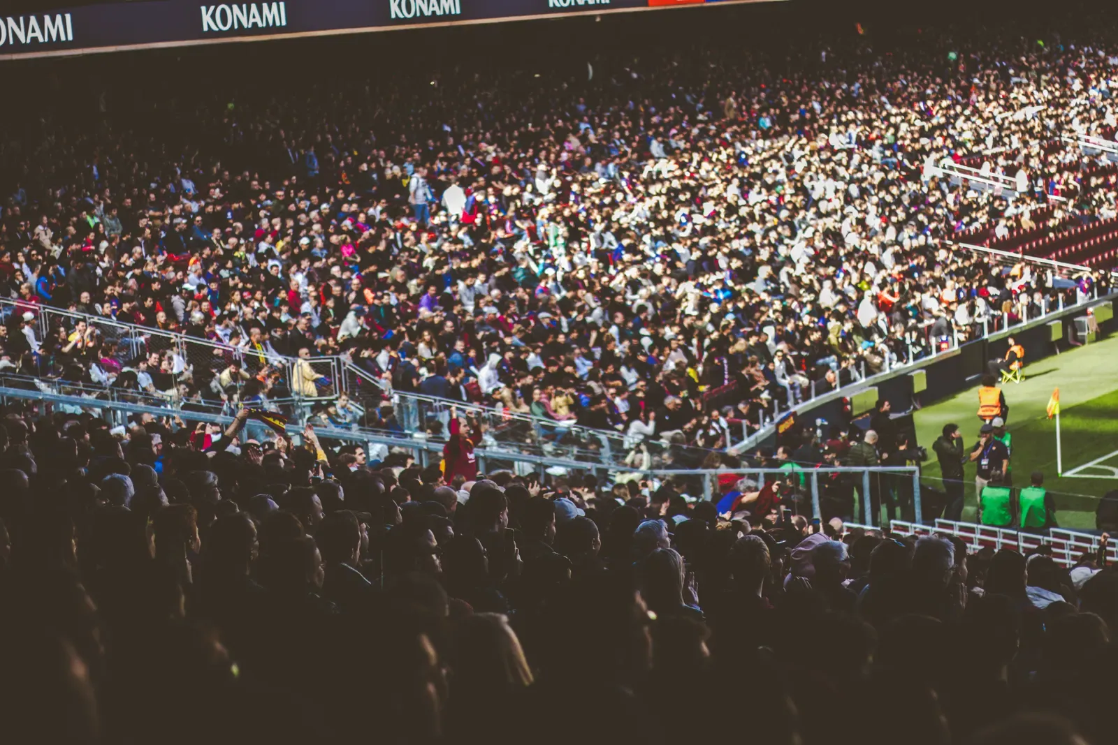 Spectators in a soccer stadium, illustrative photograph
