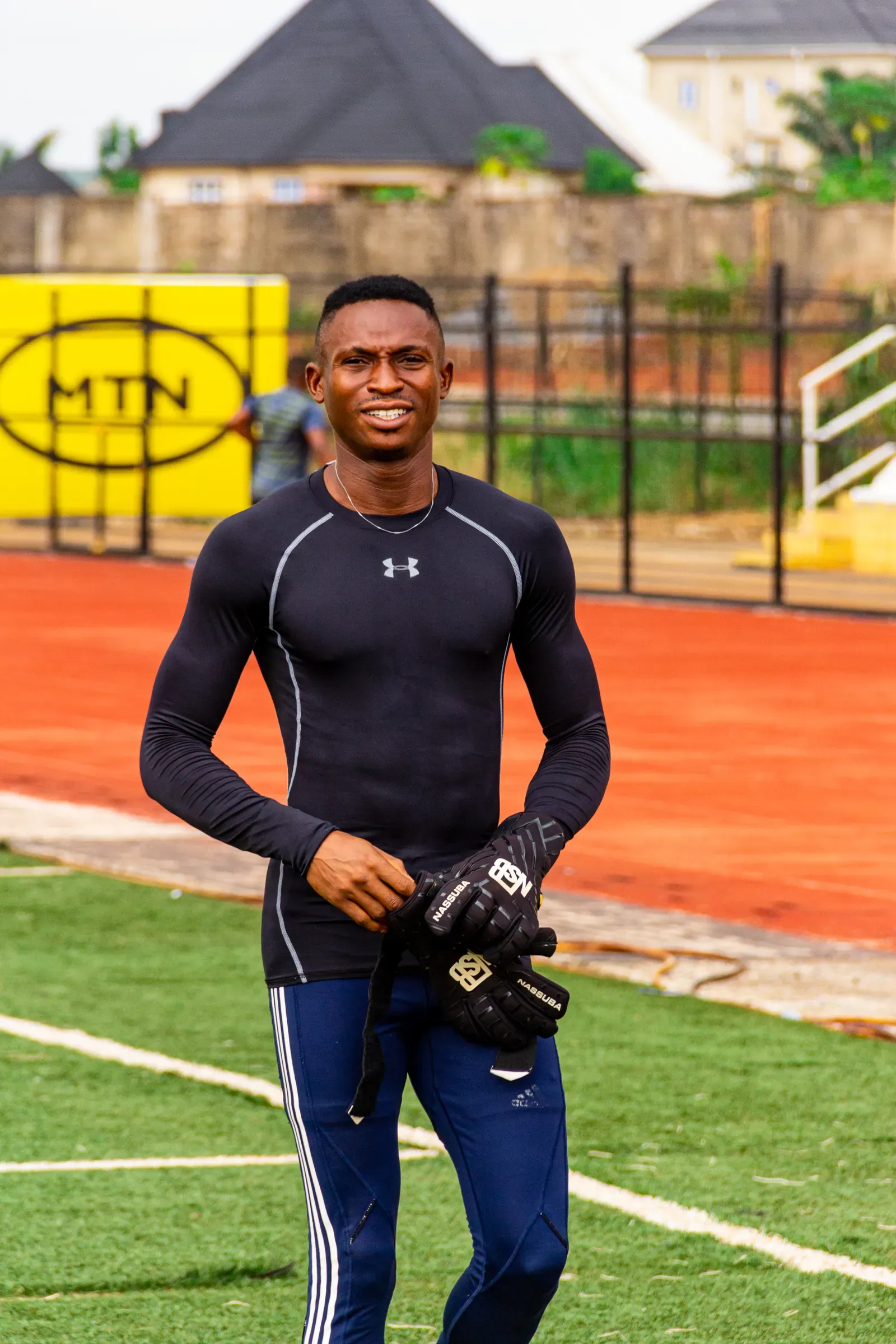 A goalkeeper holding gloves on a soccer field, illustrative photograph