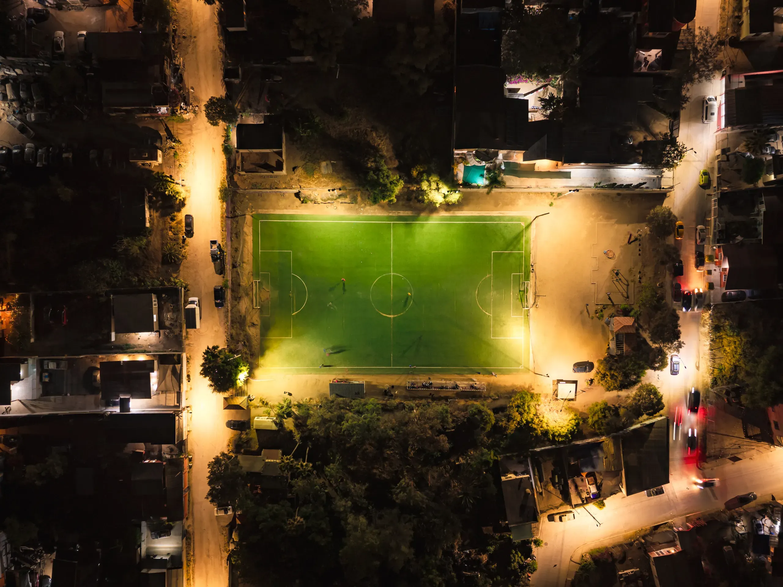A soccer field lit for an evening game