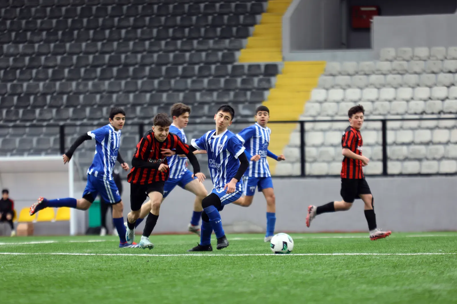 Players competing on a soccer field, illustrative photograph